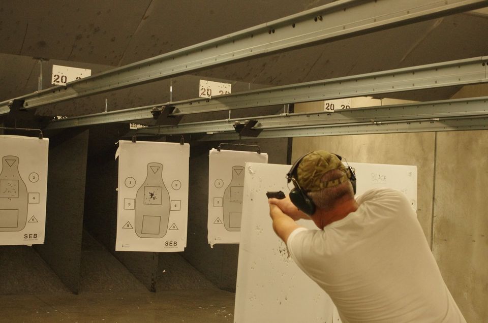 Man in white shirt at shooting range